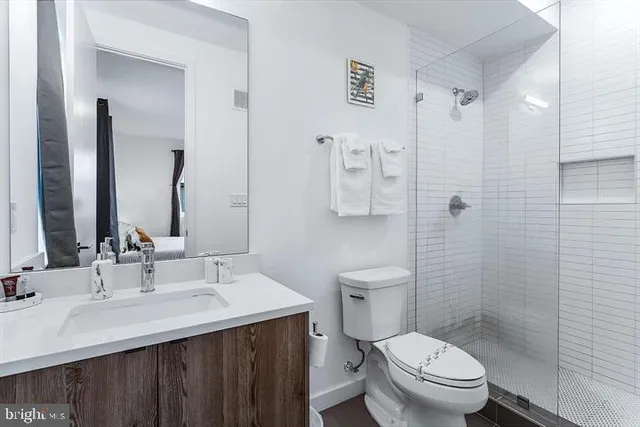 a bathroom with a sink toilet and shower