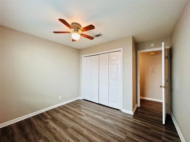 a view of open kitchen with wooden floor and electronic appliances