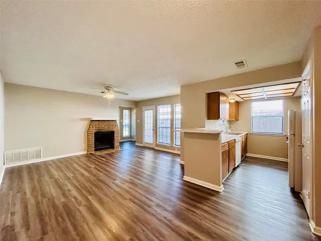 a view of a kitchen with a sink and wooden floor
