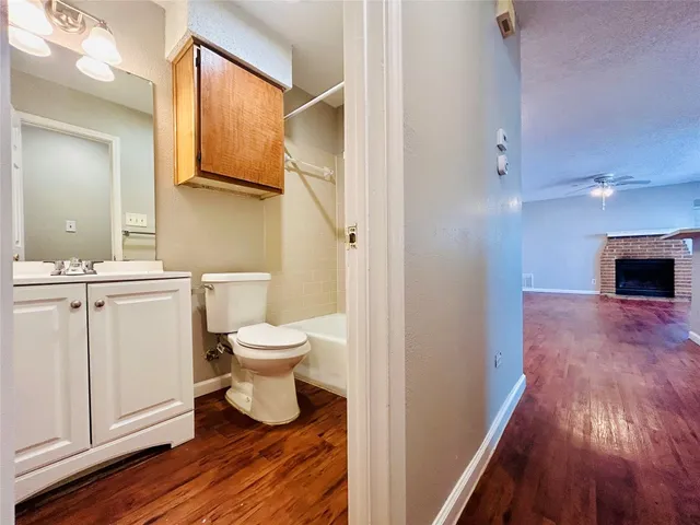 a bathroom with a toilet a sink and a mirror