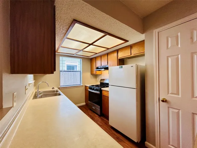 a white refrigerator freezer sitting inside of a kitchen