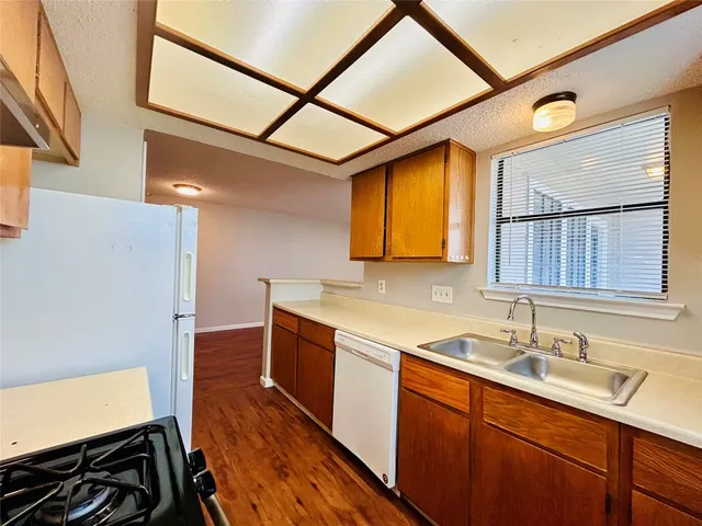 a kitchen with stainless steel appliances granite countertop a sink stove and cabinets