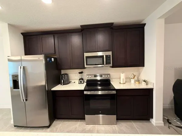 a kitchen with a sink and a refrigerator
