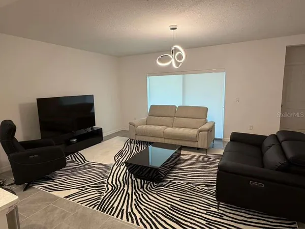 a bedroom with furniture and a flat screen tv