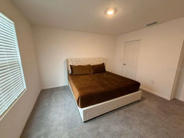 a spacious bathroom with a sink and a mirror