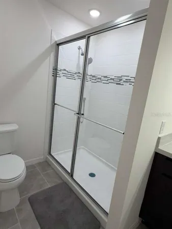 a bathroom with a shower and a toilet