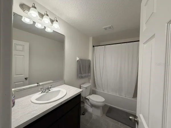 a view of bedroom with a bed and a window