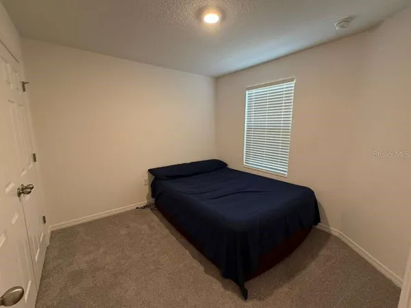 a room with a bed and a night stand