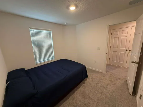 a room with a bed and a mirror