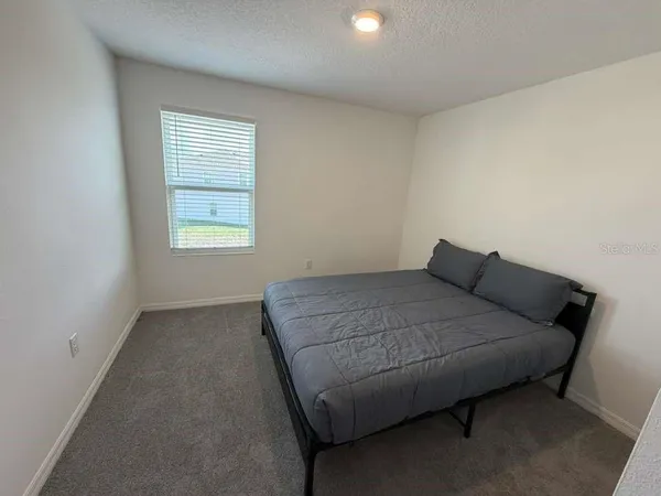 a view of a hallway with a white walls and wooden floor