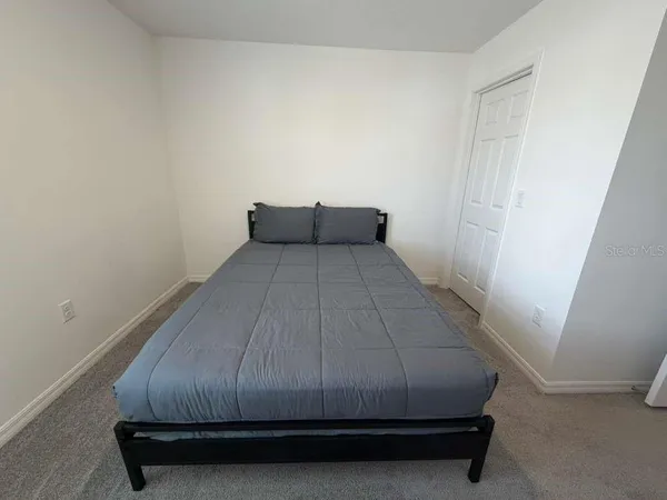 a bed sitting in a room next to a window