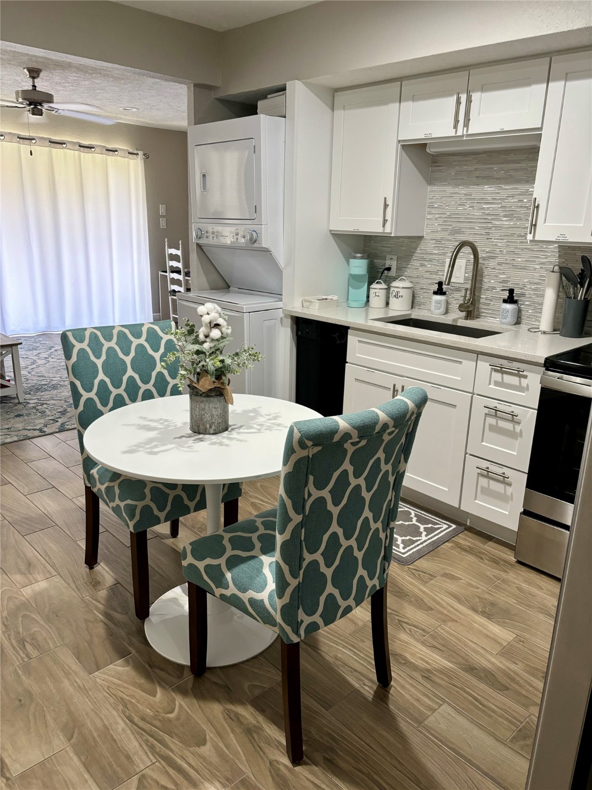 a kitchen with a table chairs and wooden floor