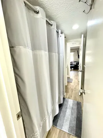a view of a bathroom with a tub and a shower