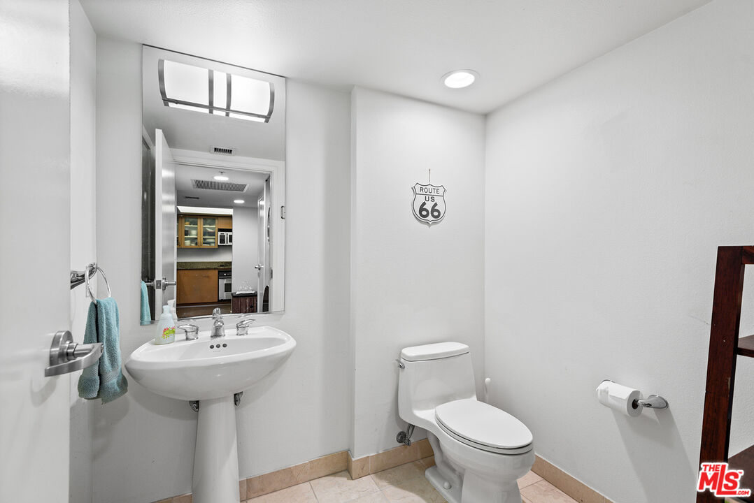 13700 Marina Pointe Drive, Unit 1520 Marina del Rey, CA 90292 - Photo 16 of 64 a bathroom with a sink a toilet and mirror