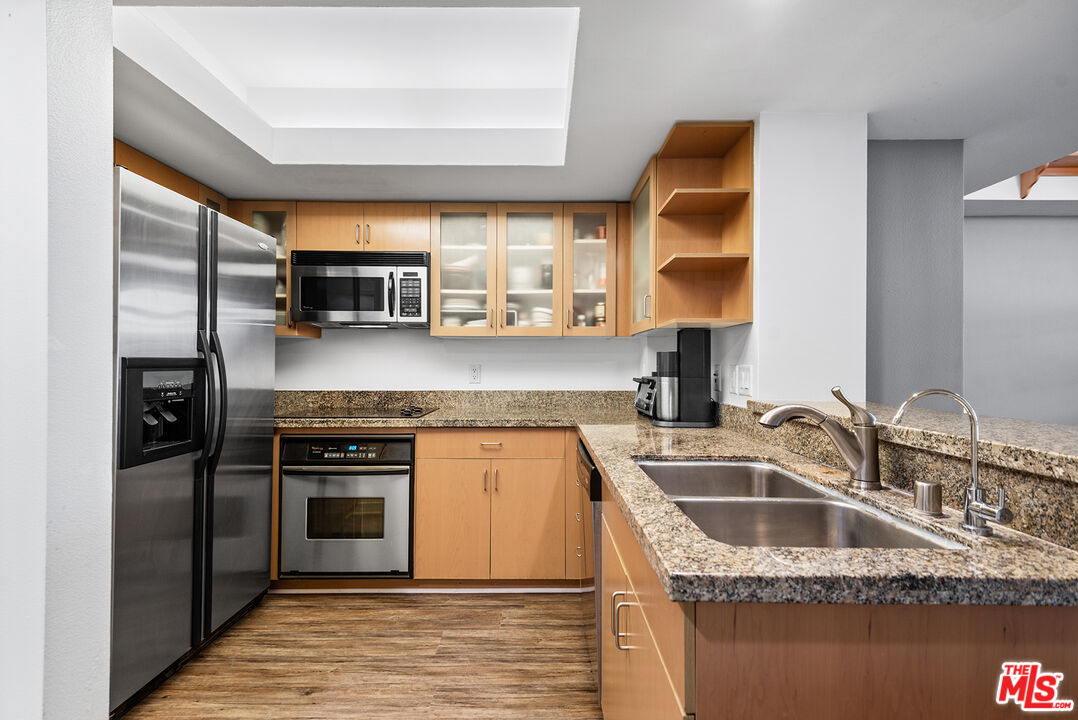 13700 Marina Pointe Drive, Unit 1520 Marina del Rey, CA 90292 - Photo 7 of 64 a kitchen with stainless steel appliances granite countertop a sink a stove and a refrigerator