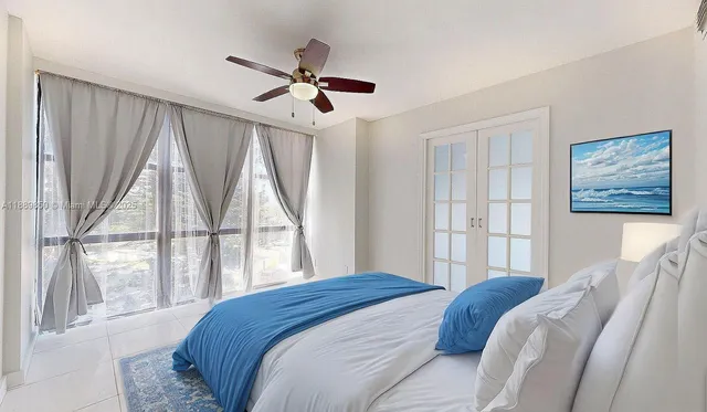 a bedroom with a large bed and a large window