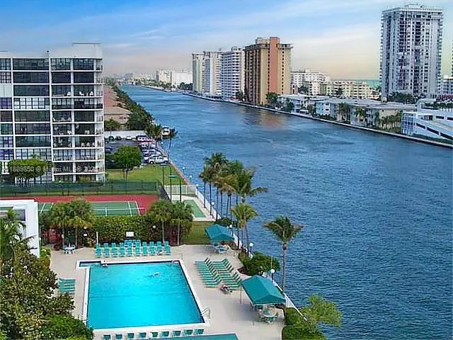 a view of a building with cars parked in front of it