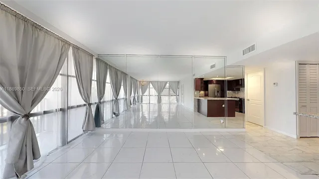 a bedroom with a large bed and a large window