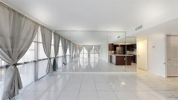 a metallic refrigerator freezer sitting inside of a kitchen