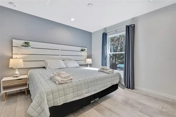 a bedroom with a bed and a window