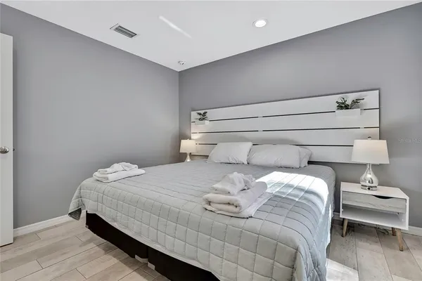 a bedroom with a bed and lamp