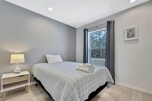 a bedroom with a bed and a lamp on table