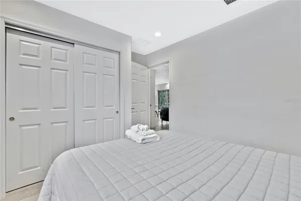 a large white bed in a white room