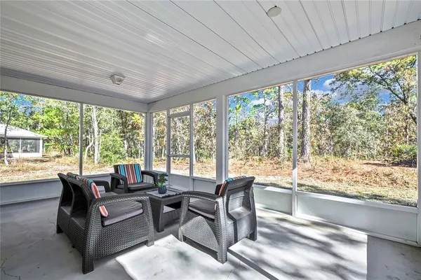 a living room with furniture and large windows