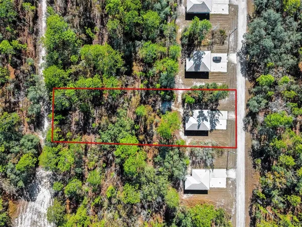 an aerial view of a house with a yard and garden