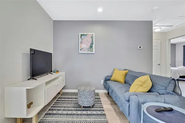 a bedroom with furniture and a flat screen tv