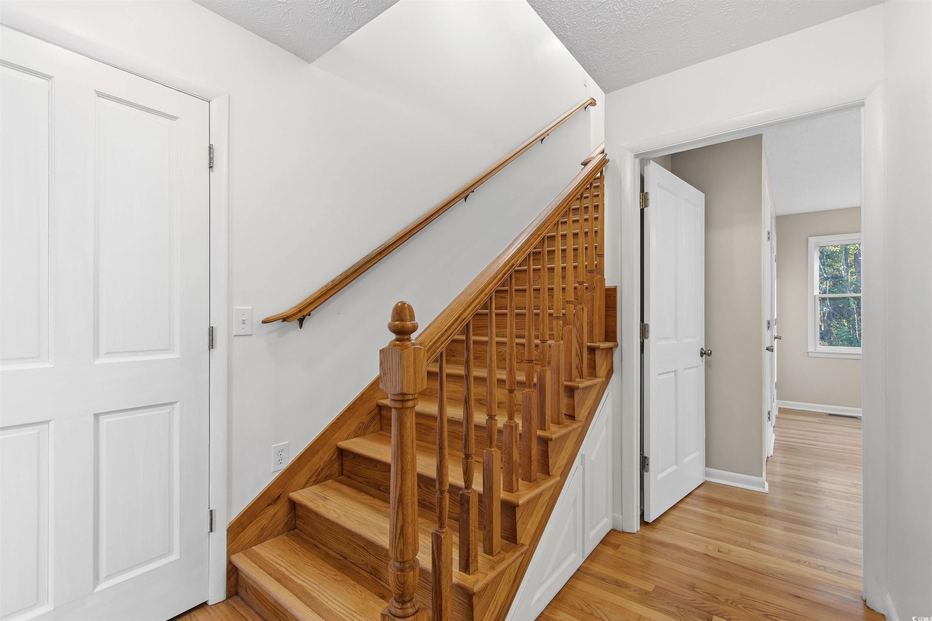 50 Irvin Enzor Road North Fair Bluff, NC 28439 - Photo 18 of 26 Staircase featuring wood finished floors and a textured ceiling