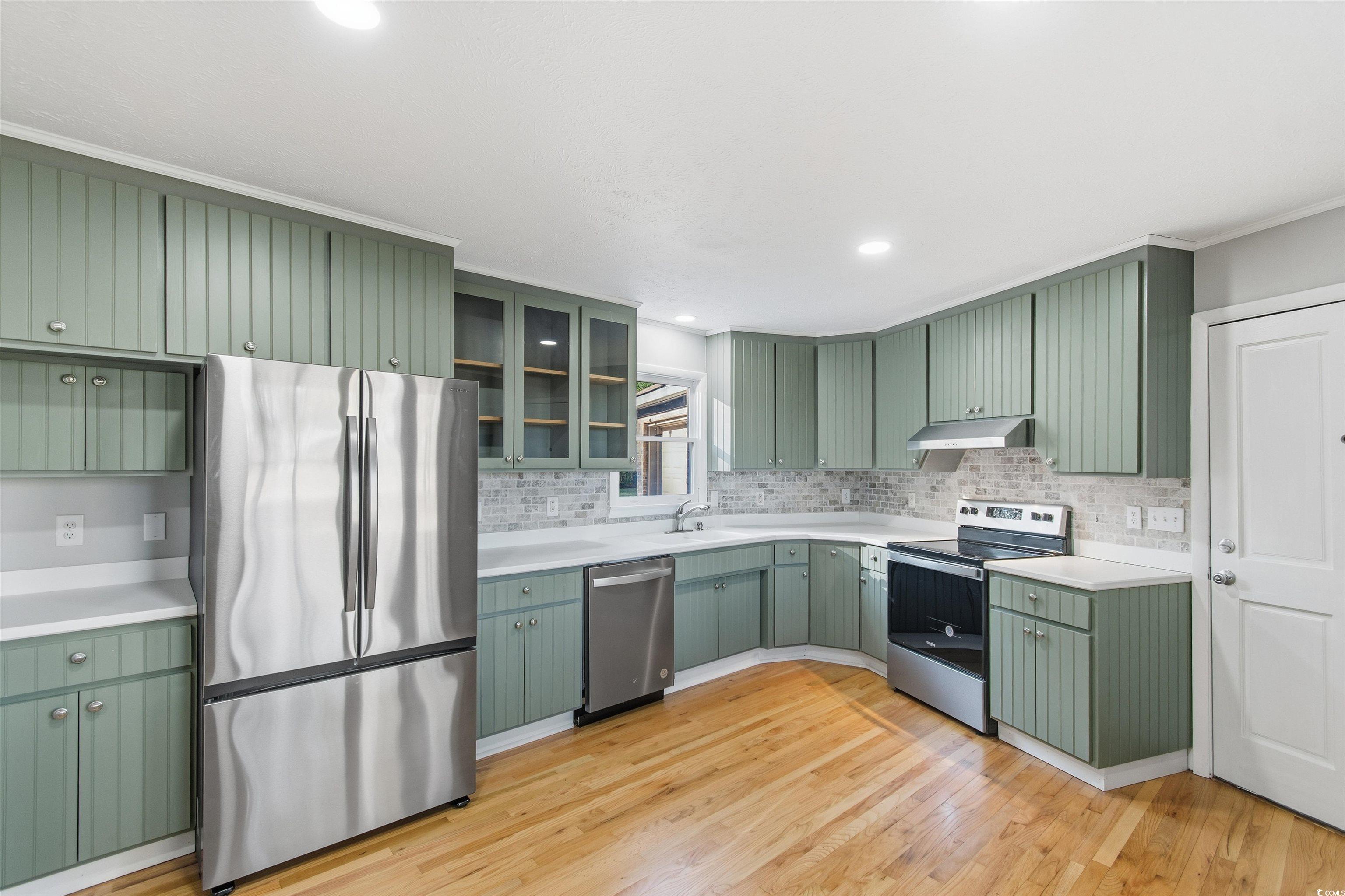 50 Irvin Enzor Road North Fair Bluff, NC 28439 - Photo 10 of 26 Kitchen featuring green cabinetry, appliances with stainless steel finishes, light countertops, and recessed lighting