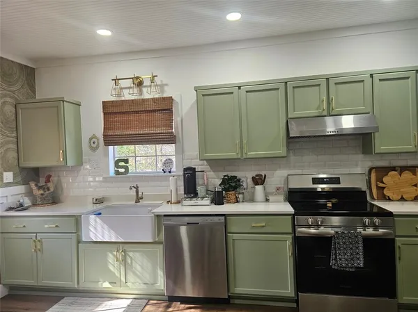 a kitchen with a sink stove and cabinets