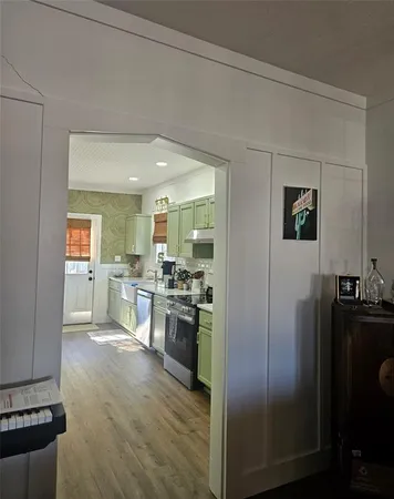 a kitchen with stainless steel appliances granite countertop a refrigerator and a stove top oven