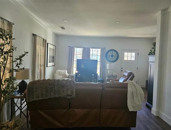 a living room with a couch and a potted plant