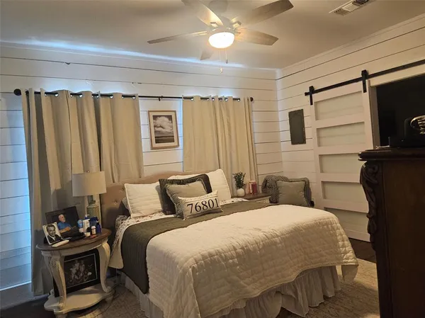 a bedroom with a bed and a television