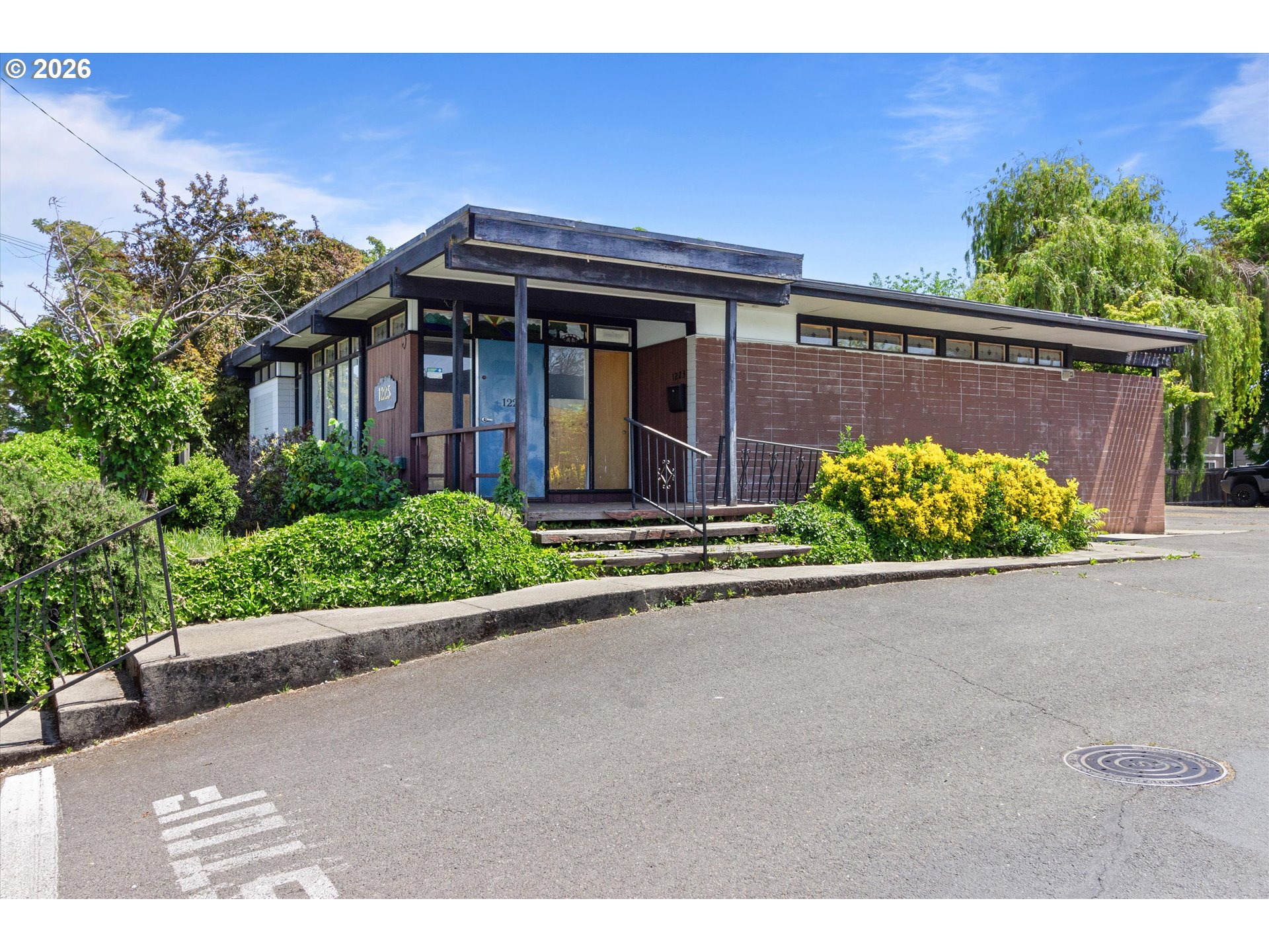 1225 West Main Street Medford, OR 97501 - Photo 1 of 45 a front view of a house with a yard