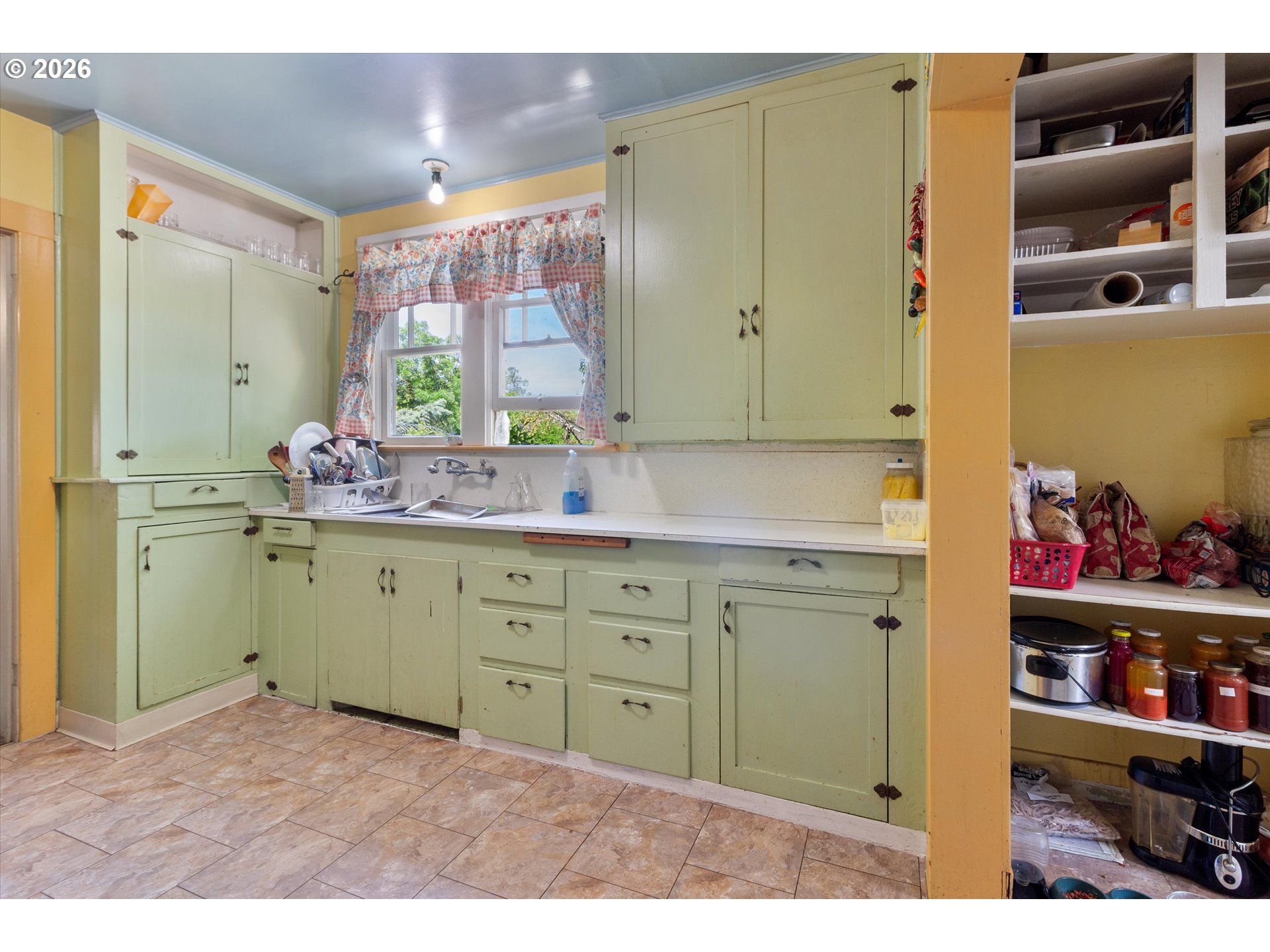 1225 West Main Street Medford, OR 97501 - Photo 16 of 45 a kitchen with cabinets a window and a sink