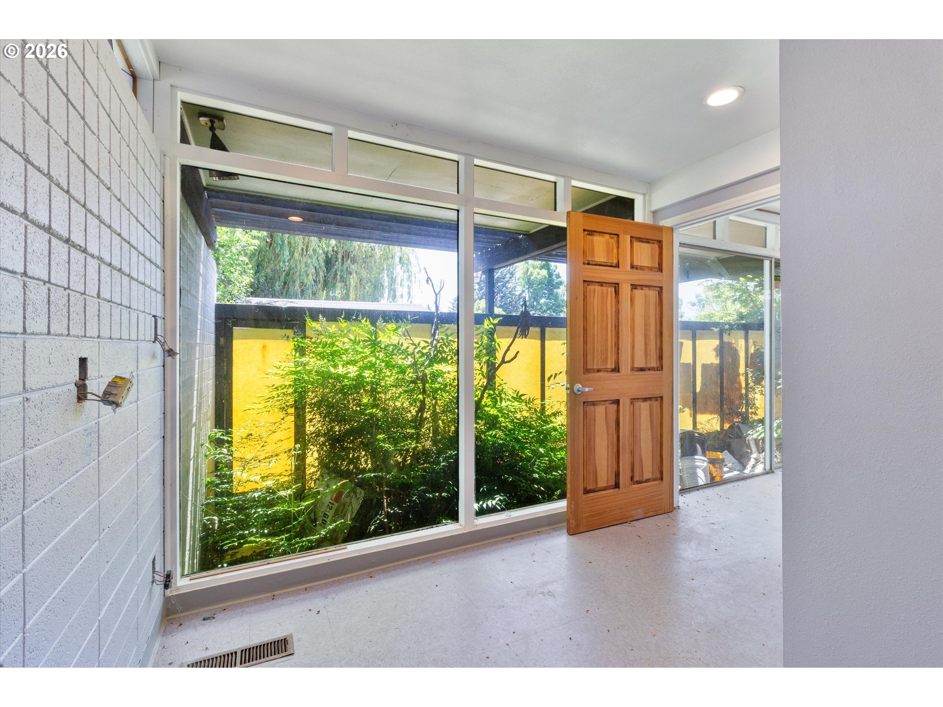 1225 West Main Street Medford, OR 97501 - Photo 40 of 45 a view of an empty room with wooden floor and a window