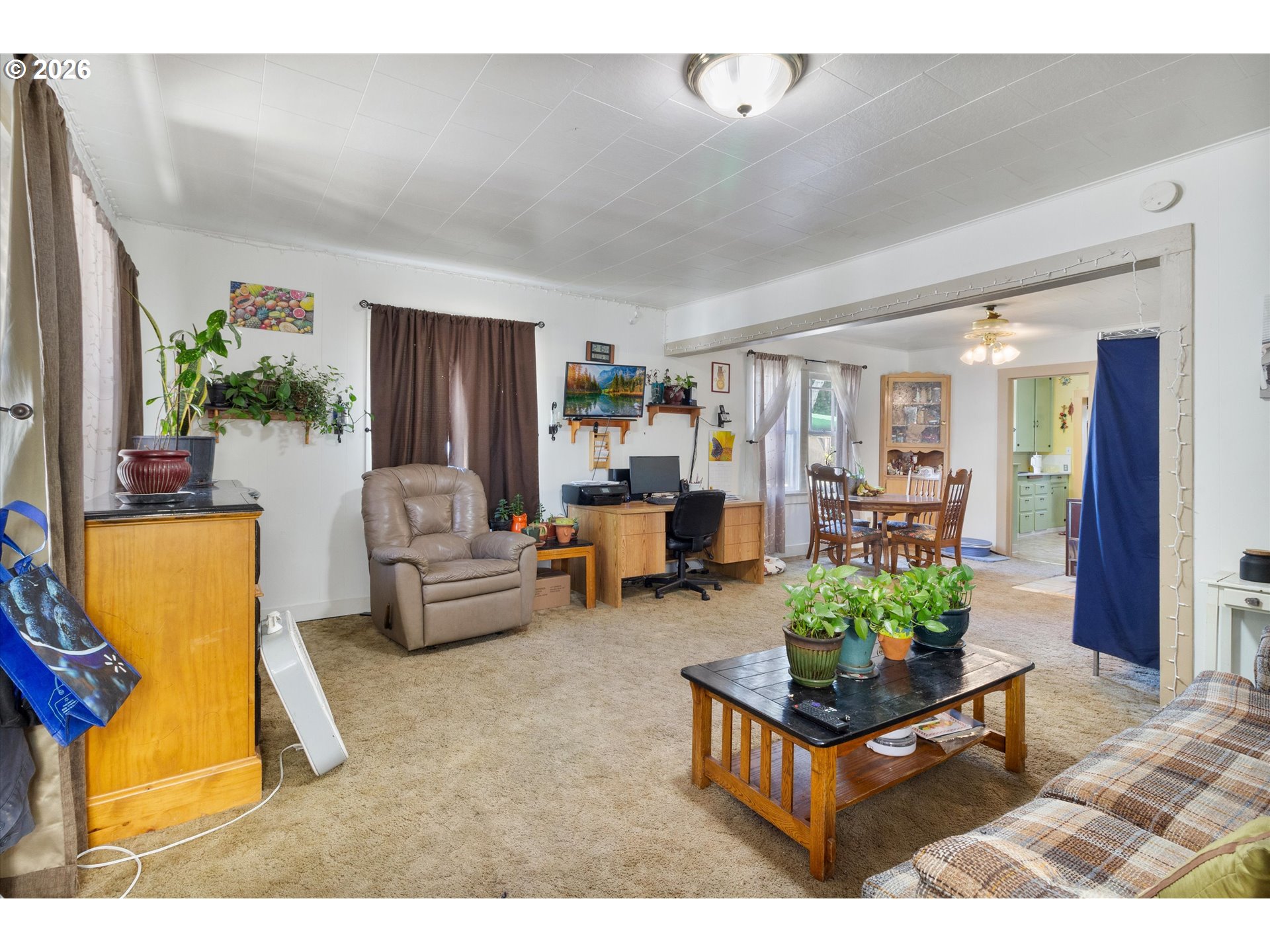 1225 West Main Street Medford, OR 97501 - Photo 6 of 45 a living room with furniture and a potted plant