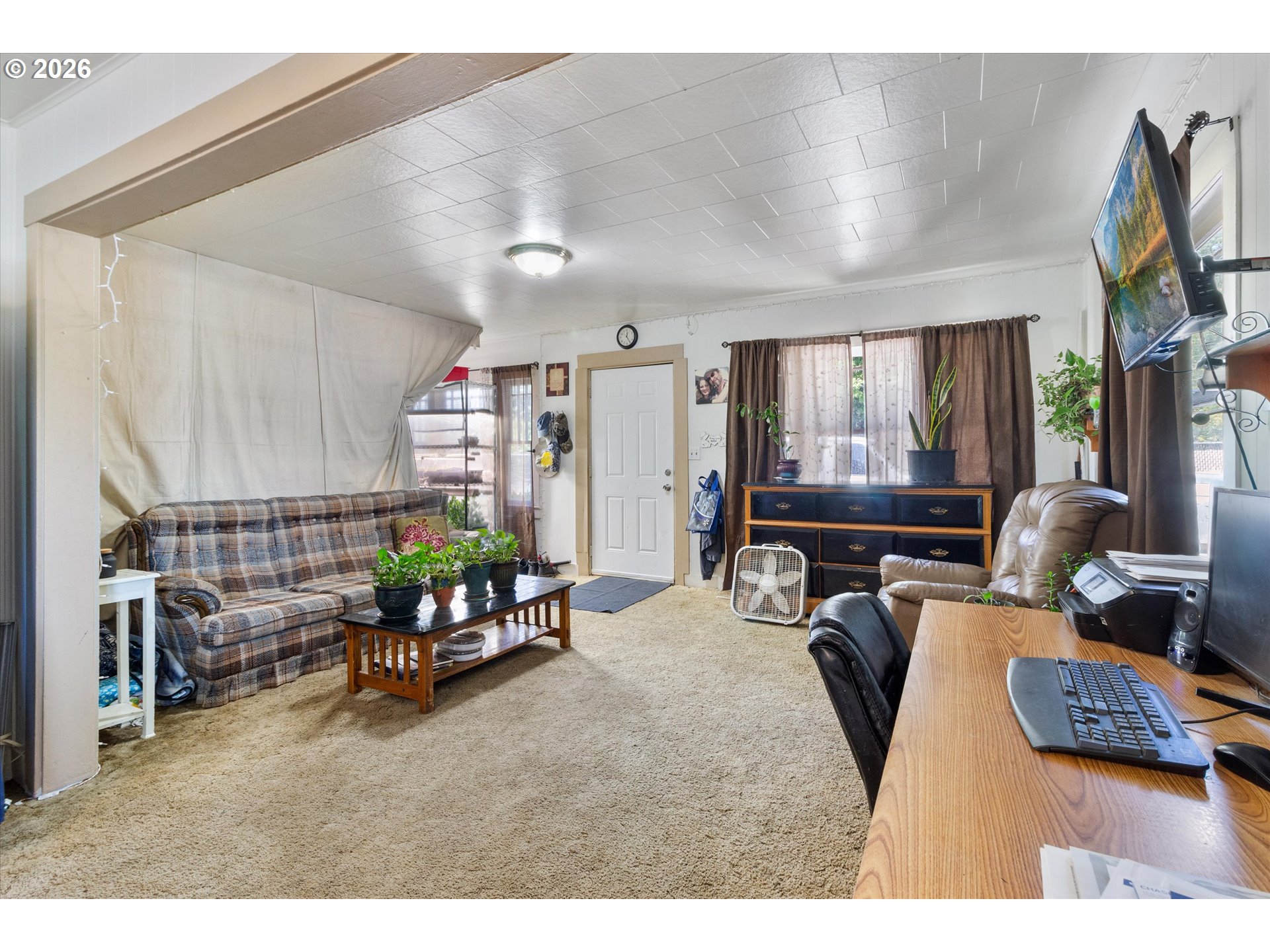 1225 West Main Street Medford, OR 97501 - Photo 10 of 45 a bedroom with furniture and a flat screen tv