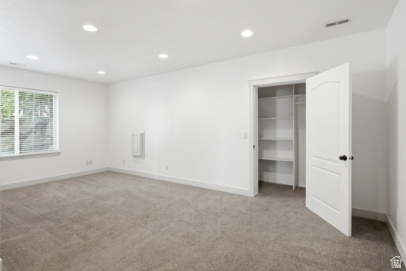 722 West Webb Circle, Unit 2 Draper, UT 84020 - Photo 25 of 39 Recessed lighting, carpet flooring, a window with blinds, a built-in closet with shelving, and a panel door