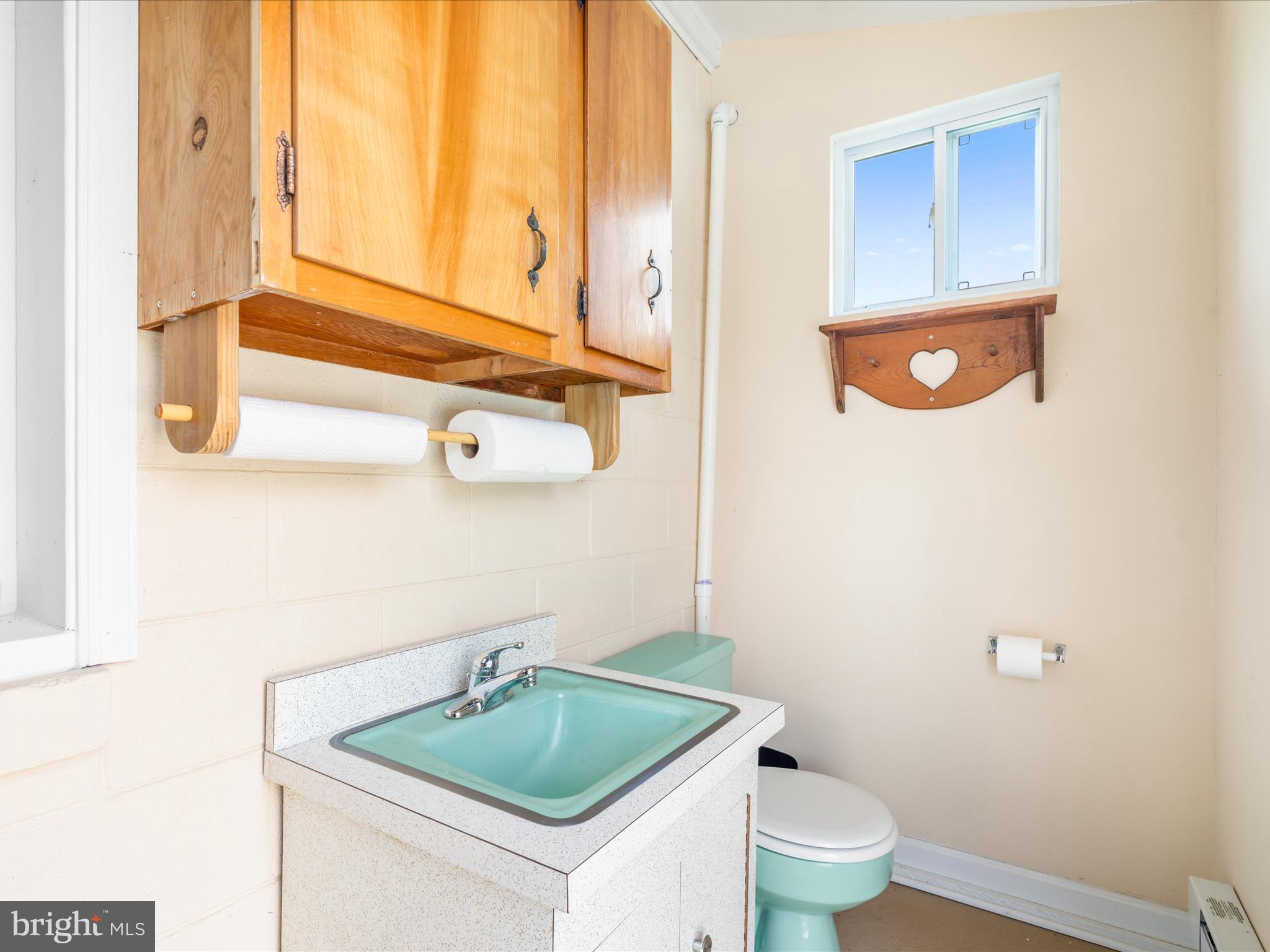 4514 Araby Church Road Frederick, MD 21704 - Photo 54 of 89 a bathroom with a granite countertop sink and a toilet