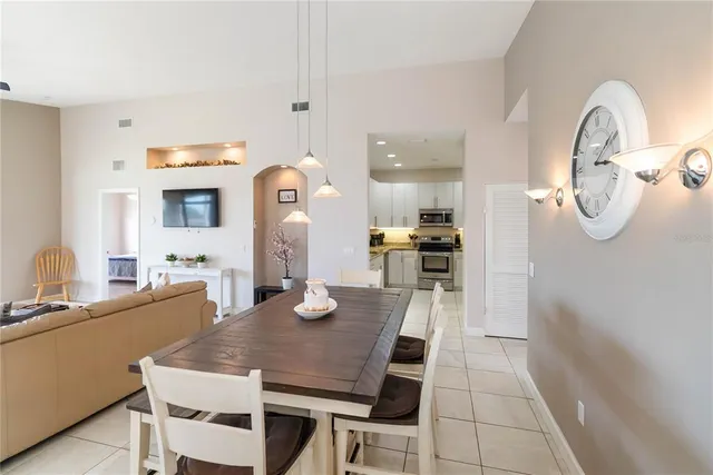 a kitchen with a refrigerator sink and white cabinets
