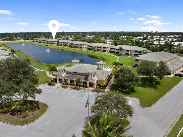 a view of a house with a yard and sitting area