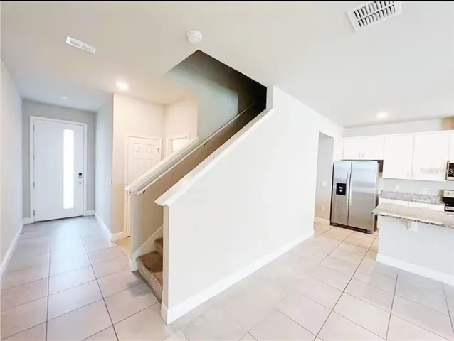 a view of a kitchen with furniture and an entryway