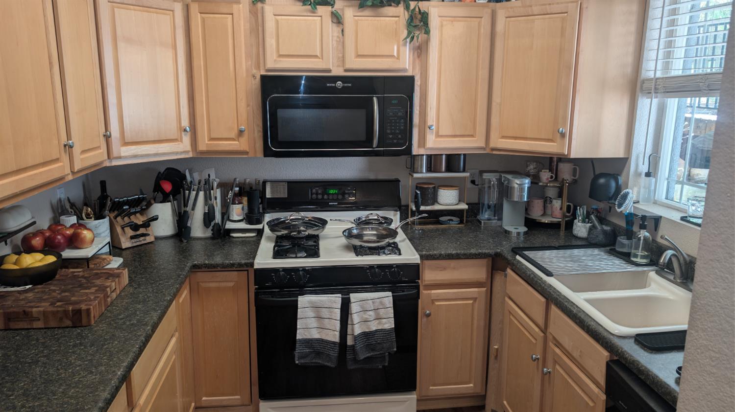 3248 Sudbury Road Cameron Park, CA 95682 - Photo 36 of 41 a kitchen with stainless steel appliances granite countertop a sink stove and microwave