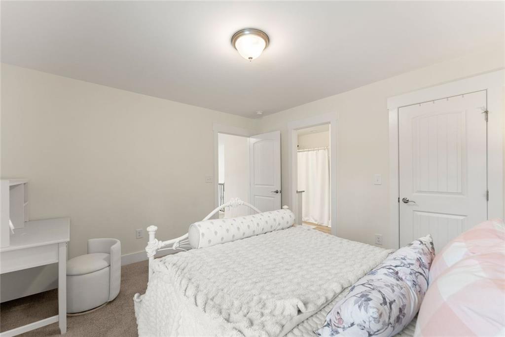 6998 Britt Gailey Road Clermont, GA 30527 - Photo 51 of 92 a bedroom with a bed and a chair