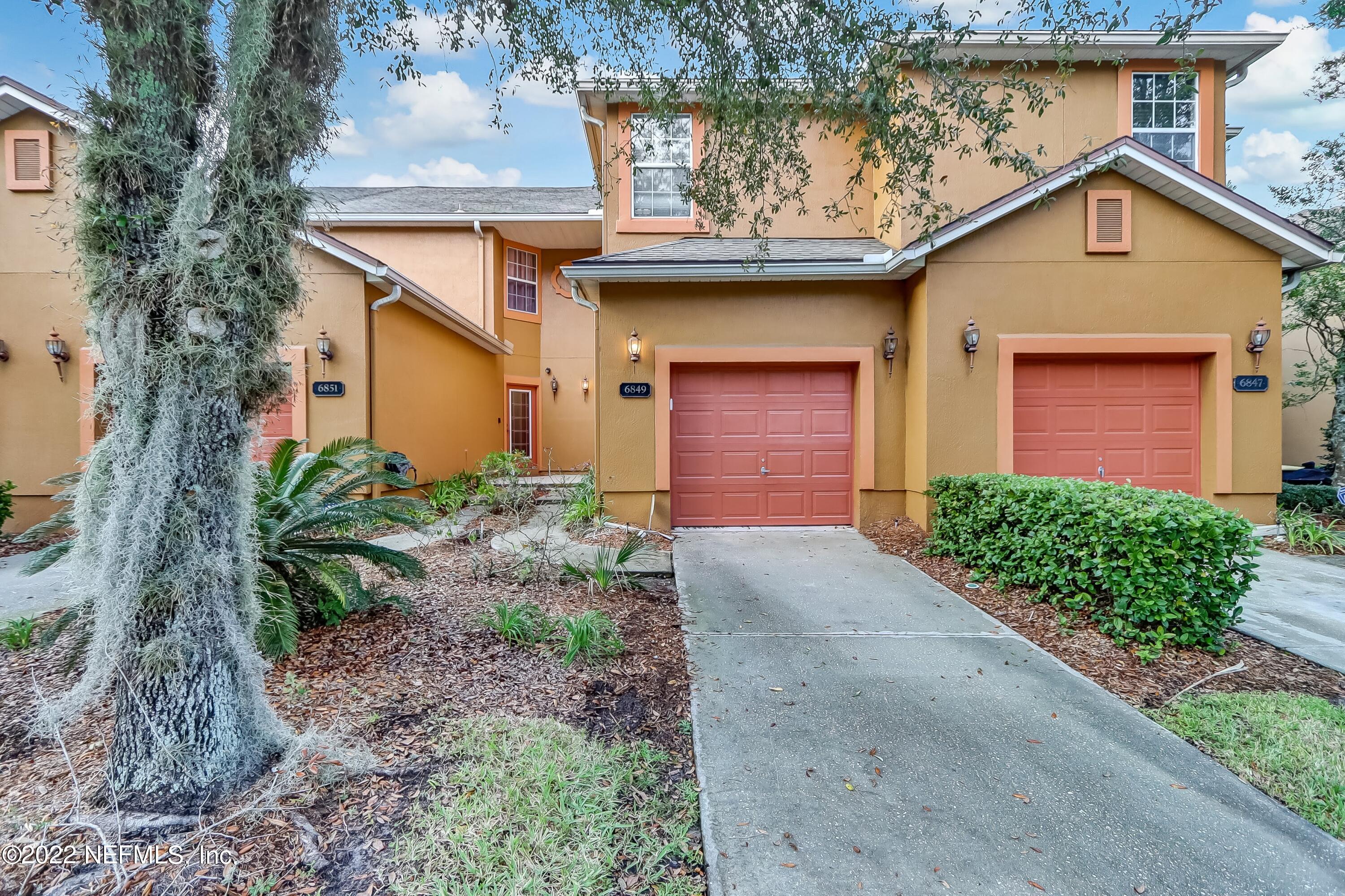 6849 Misty View Drive Jacksonville, FL 32210 - Photo 1 of 21 a front view of a house with garden