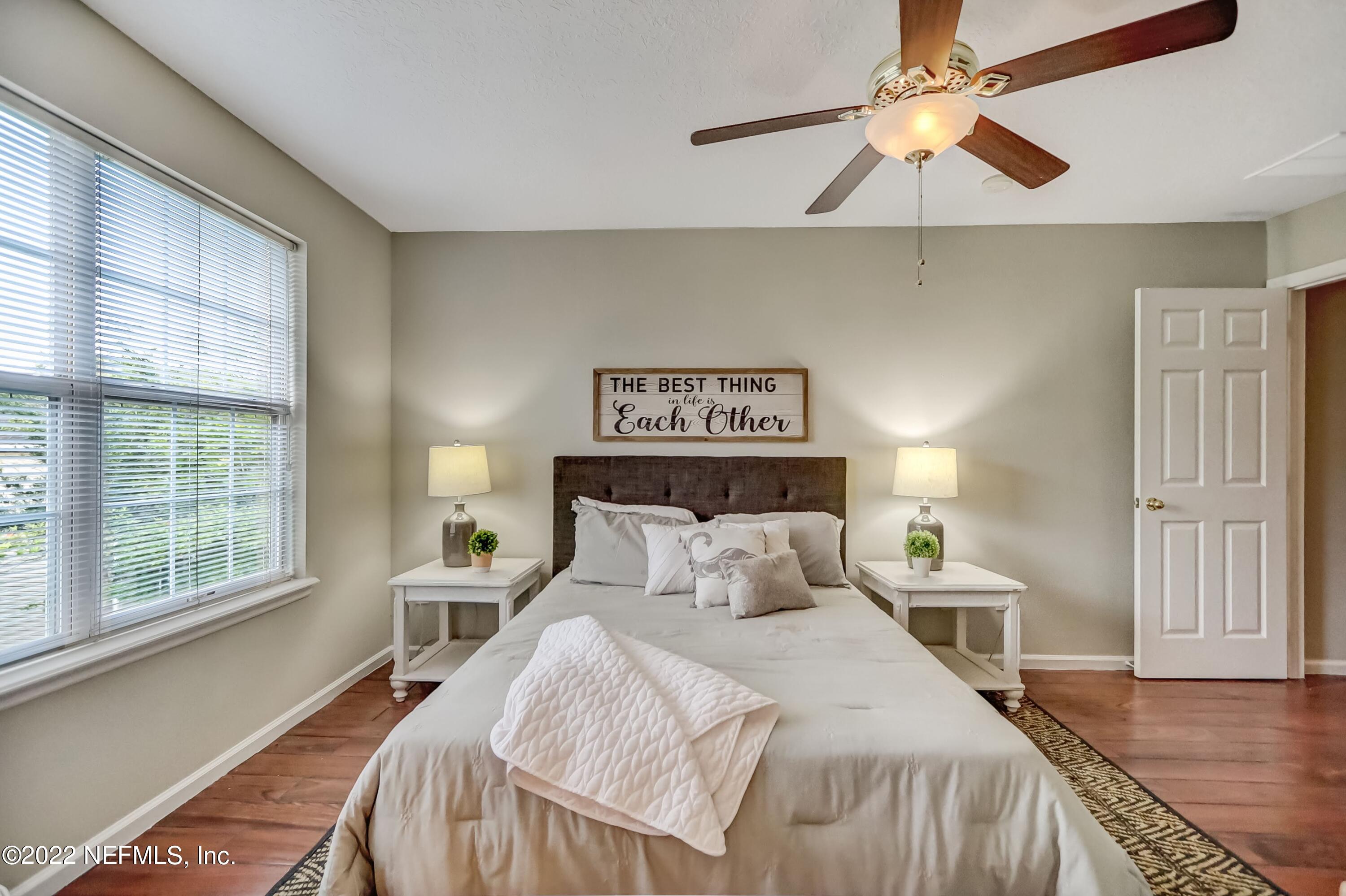 6849 Misty View Drive Jacksonville, FL 32210 - Photo 14 of 21 a bedroom with a large bed and a chandelier